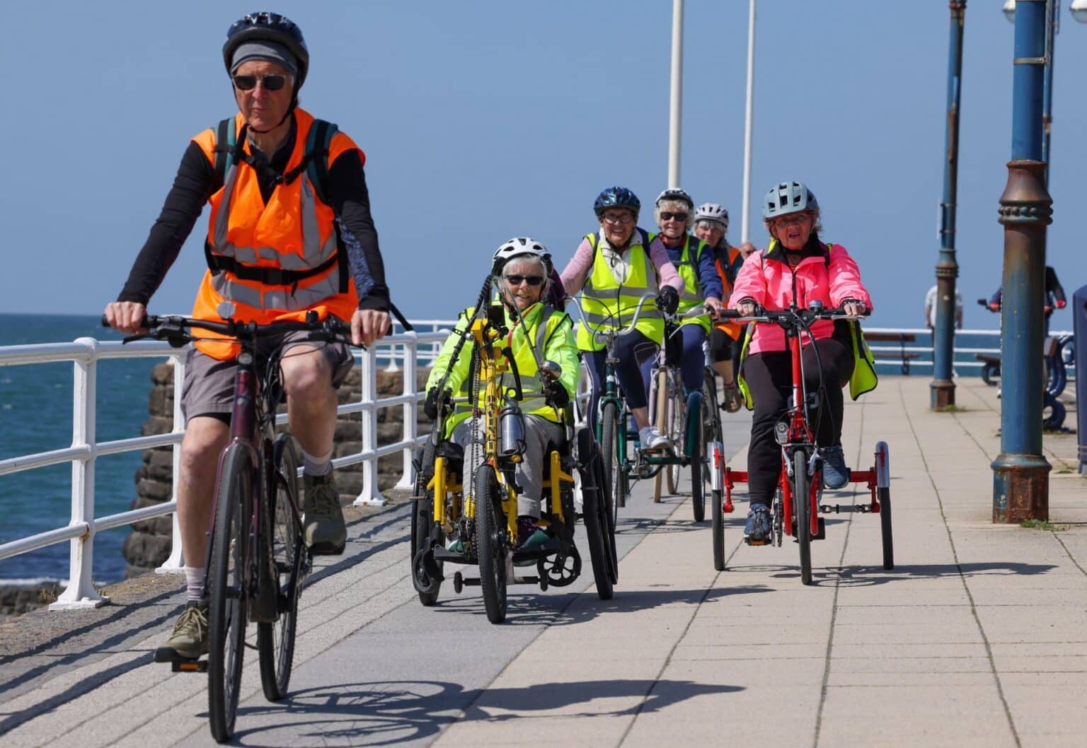 Cyclists using adapted bikes gathered for a community ride.